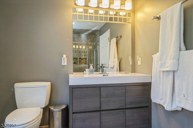 bathroom featuring vanity, toilet, and an enclosed shower