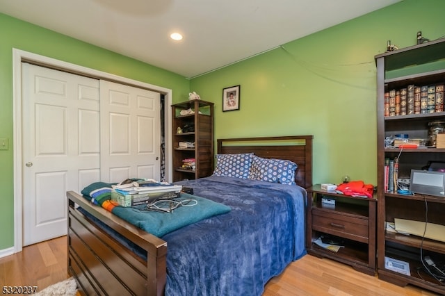 bedroom featuring light hardwood / wood-style floors and a closet