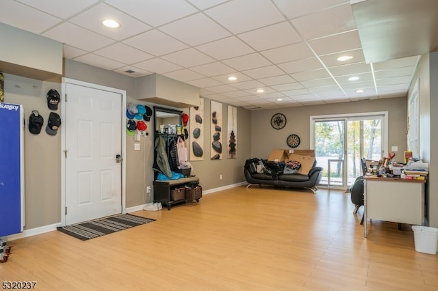 entrance foyer featuring a paneled ceiling and light hardwood / wood-style flooring