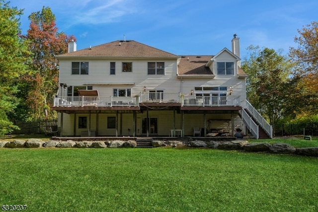 back of property featuring a yard and a deck