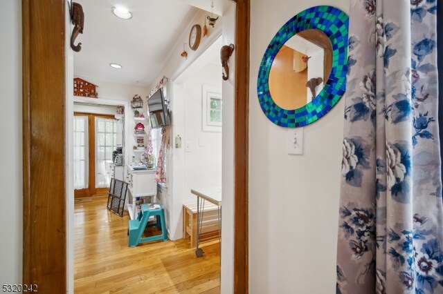 corridor with light hardwood / wood-style flooring