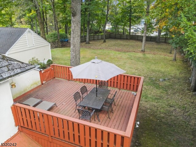 wooden terrace with a lawn