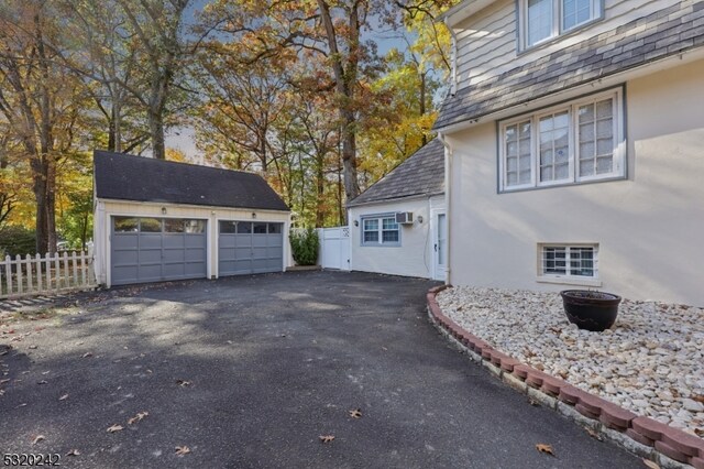 view of side of home featuring an outdoor structure and a garage