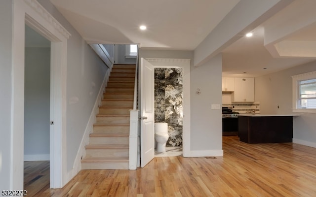 staircase with wood-type flooring