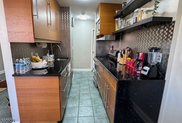 kitchen with tasteful backsplash, appliances with stainless steel finishes, sink, tile patterned flooring, and ventilation hood