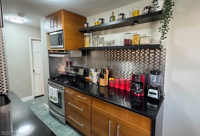 kitchen featuring tile patterned floors, stainless steel appliances, and tasteful backsplash