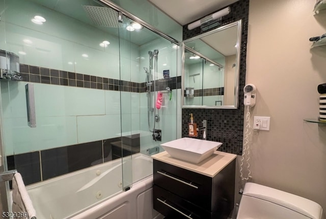 full bathroom with toilet, vanity, shower / bath combination with glass door, and backsplash