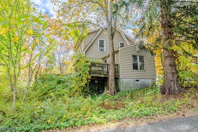 view of home's exterior featuring a wooden deck