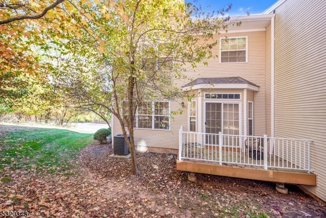 exterior space with central air condition unit and a deck