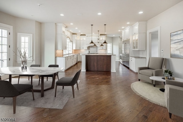 dining area with sink and dark hardwood / wood-style floors