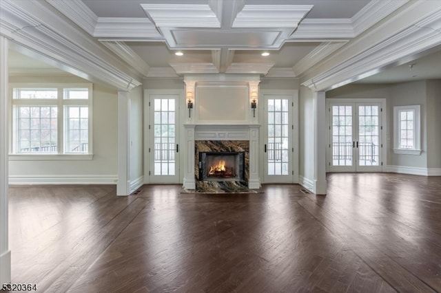 unfurnished living room featuring french doors, crown molding, coffered ceiling, a premium fireplace, and dark wood-type flooring