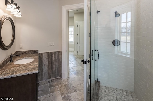 bathroom with walk in shower and vanity