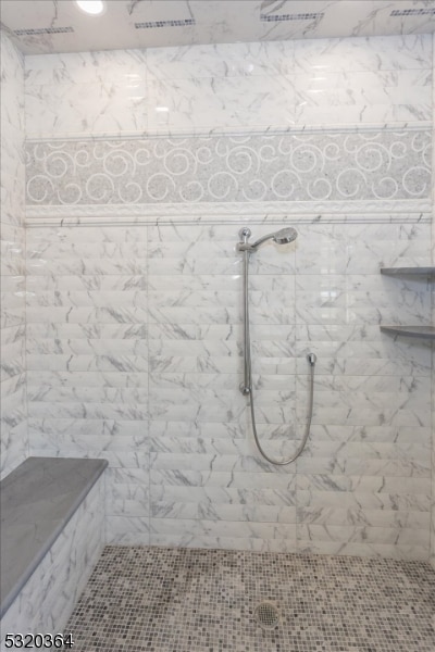 bathroom with a tile shower