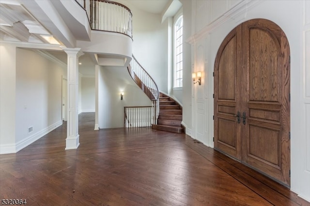 entryway with dark hardwood / wood-style flooring, decorative columns, a high ceiling, and beamed ceiling