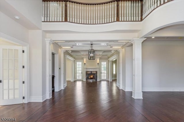 4 Hall Rd, Chester Twp, NJ 07930 - unfurnished living room featuring decorative columns, wood finished floors, a warm lit fireplace, baseboards, and crown molding