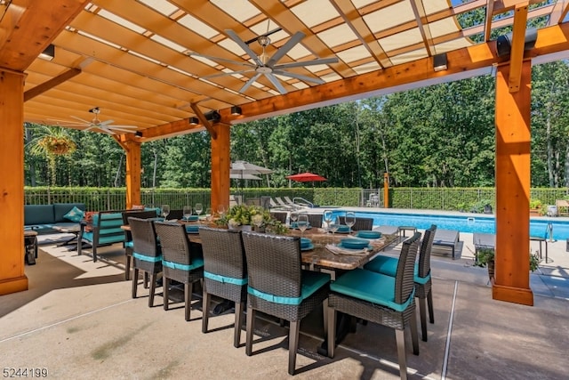 view of patio with ceiling fan and a fenced in pool