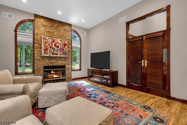 living room featuring hardwood / wood-style floors, a fireplace, and plenty of natural light