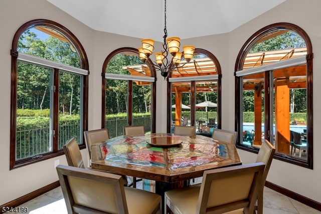 tiled dining room with vaulted ceiling and an inviting chandelier