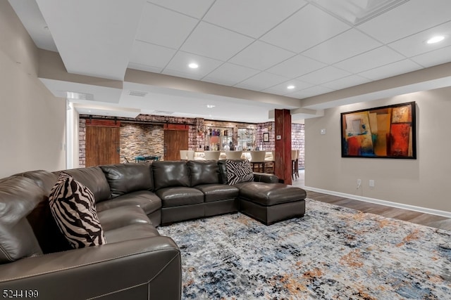 living room featuring hardwood / wood-style floors and a paneled ceiling