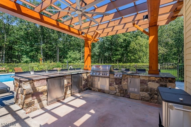 view of patio / terrace featuring exterior kitchen, grilling area, and a pergola