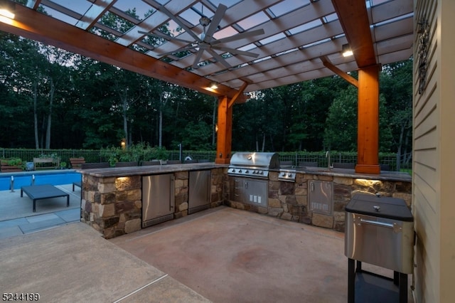 view of patio featuring an outdoor kitchen, area for grilling, a fenced in pool, and a pergola