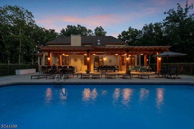 pool at dusk with a patio