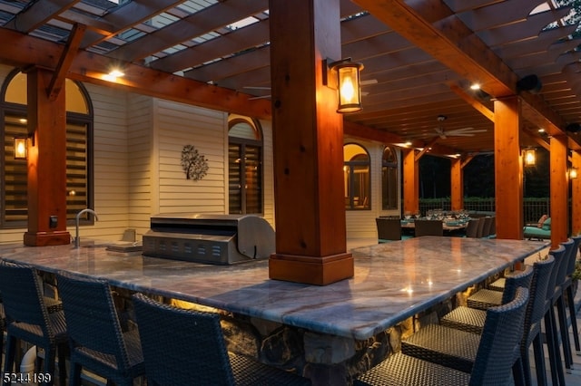 view of patio with a bar, ceiling fan, grilling area, and a pergola