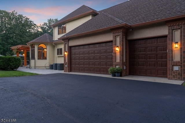 view of front of property with central AC and a garage