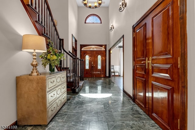 foyer entrance featuring a towering ceiling