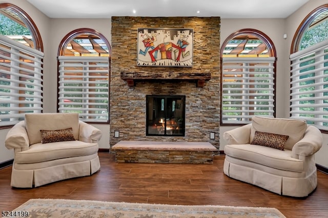 sitting room featuring wood-type flooring and a wealth of natural light