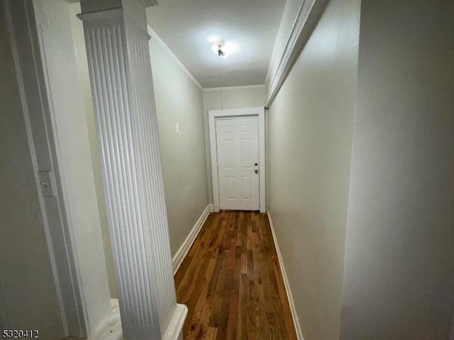 corridor featuring dark hardwood / wood-style flooring and ornamental molding