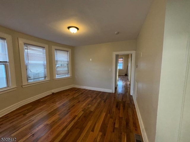 unfurnished room featuring dark hardwood / wood-style flooring