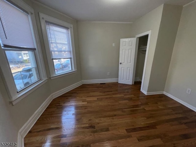 spare room with dark wood-type flooring