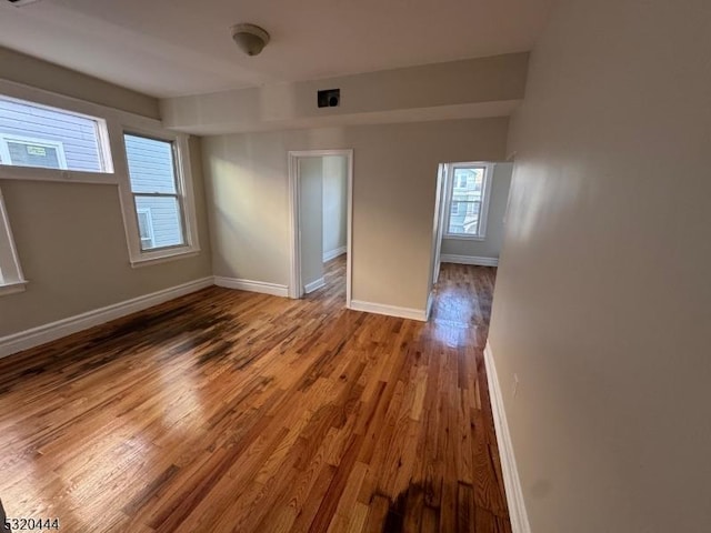 empty room with hardwood / wood-style flooring