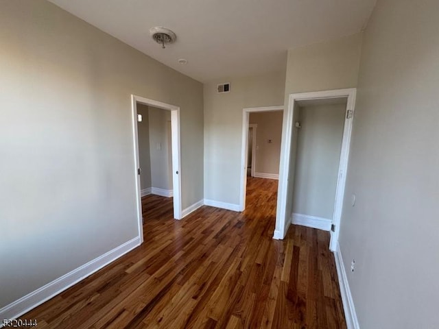 unfurnished room featuring dark wood-type flooring