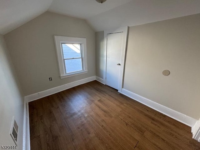 additional living space with dark hardwood / wood-style floors and lofted ceiling