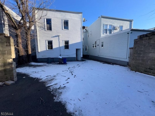 view of snow covered rear of property