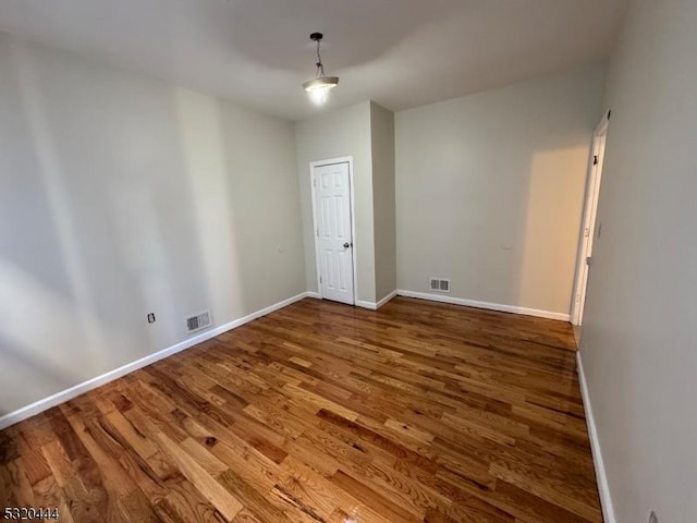 empty room with wood-type flooring