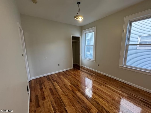 unfurnished bedroom with wood-type flooring and a closet