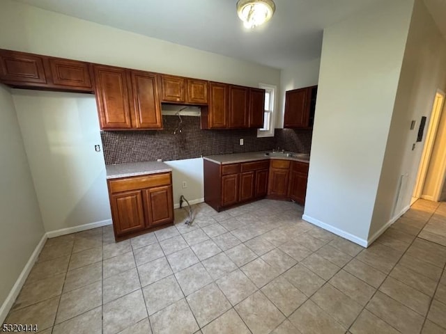 kitchen featuring light tile patterned floors and backsplash