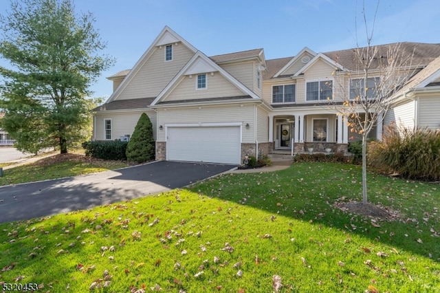 craftsman house featuring a garage and a front lawn