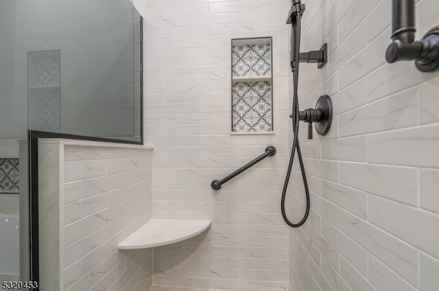 bathroom with a tile shower