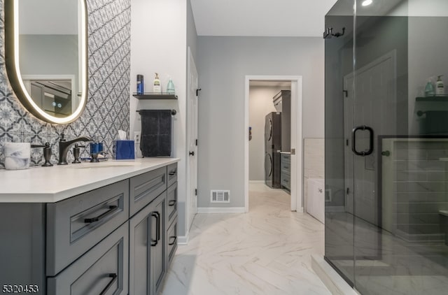 bathroom with backsplash, vanity, and an enclosed shower