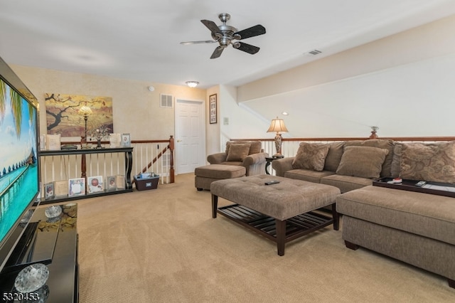 carpeted living room with ceiling fan