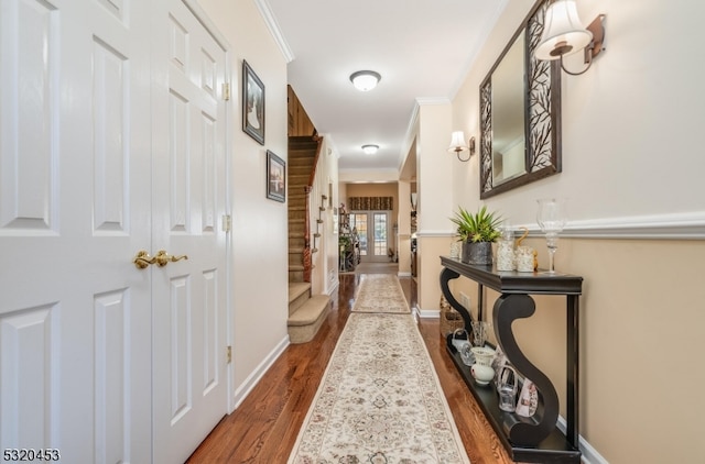 corridor featuring hardwood / wood-style flooring and ornamental molding