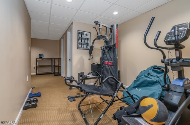 workout room with carpet flooring and a drop ceiling