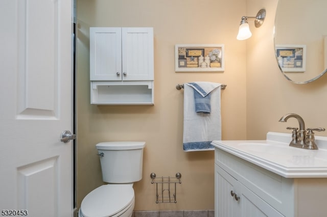 bathroom featuring toilet and vanity