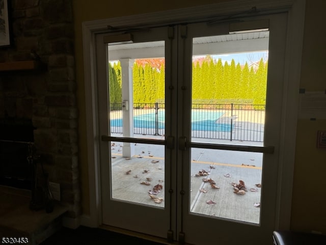 doorway to outside with french doors and a healthy amount of sunlight