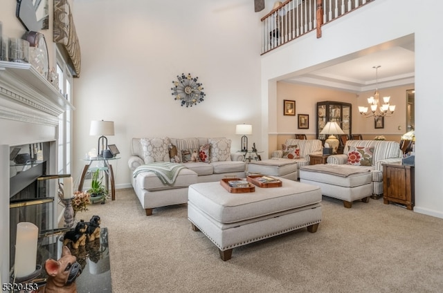 carpeted living room with a high ceiling and an inviting chandelier