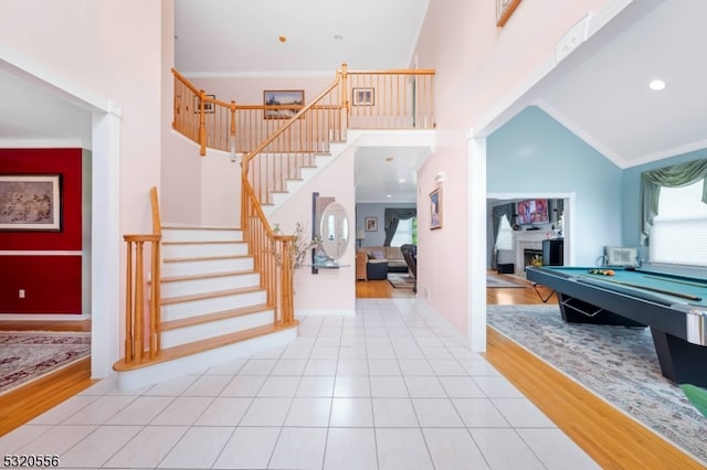 entrance foyer with light hardwood / wood-style floors, high vaulted ceiling, and billiards